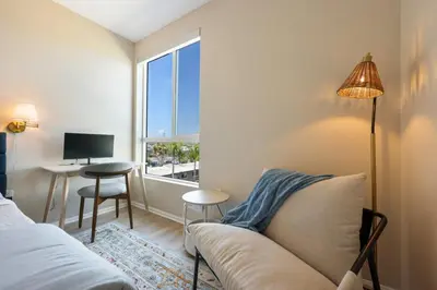 a living room with a couch and a window at North Park Modern 2BR King Beds, Workspaces, Parking in San Diego