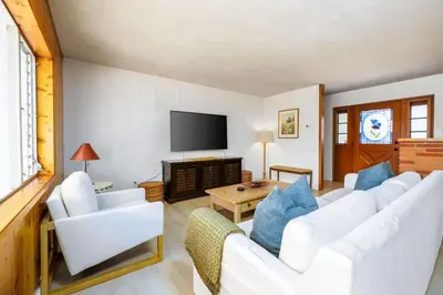 a living room with white furniture and a flat screen tv at 3Bed Single Level Home in Carlsbad