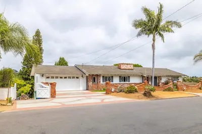 a house with a palm tree in front of it at 3Bed Single Level Home in Carlsbad