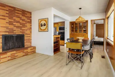 a dining room with a table and a fireplace at 3Bed Single Level Home in Carlsbad
