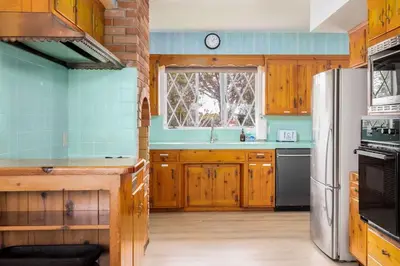 a kitchen with wooden cabinets and a refrigerator at 3Bed Single Level Home in Carlsbad