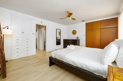 a bedroom with a large bed with a wooden headboard at 3Bed Single Level Home in Carlsbad