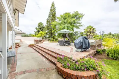 a patio with a table and an umbrella at Spacious 2 Bed in Carlsbad in Carlsbad
