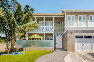 a house with a palm tree in front of it at Private Encinitas Casita & Patio in Encinitas