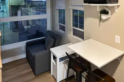 a living room with a couch and a table at Pool and Hot Tub Access Cozy Perris Tiny Home in Perris