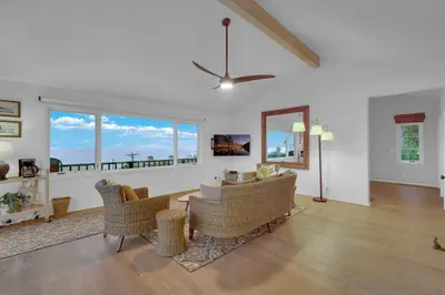 a living room with a couch and chairs and windows at Fairway Retreat, Stylish Coastal Home Near Golf, Beaches & Carlsbad Fun in Encinitas