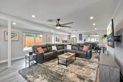 a living room with a couch and a ceiling fan at Steps to Beach, 2BR Dog Friendly Home with Fire Pit in Carlsbad