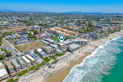 an aerial view of a beach with people and the ocean at Direct Beach Access, Views, Carlsbad 2BR Upper Unit in Carlsbad