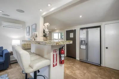 a kitchen and living room with a bar and a fire hydrant at Oceanside Bungalow, Walk to Beach & Pier, Private Hot Tub, Beach Gear in Oceanside