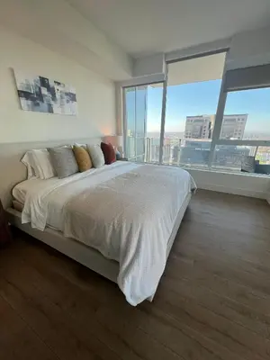 a bedroom with a large bed and large windows at The Daisy Bright 2BR Stay in Downtown San Diego in San Diego