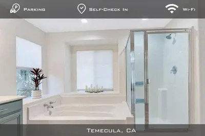 a bathroom with a bath tub and a shower at Spacious Extended Stay Temecula in Temecula