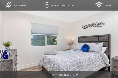 a bedroom with a bed and a window at Spacious Extended Stay Temecula in Temecula
