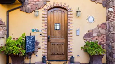 a wooden door on the side of a building at 2 Homes in Bella Vista Rd by AvantStay Sleeps 8 Vineyard Views Patios in Temecula Wine Trail in Temecula
