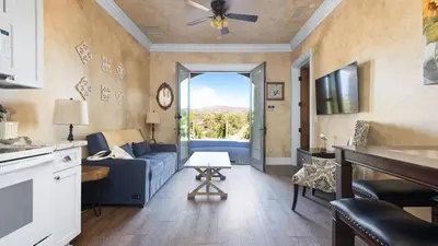 a living room with a blue couch and a window at 2 Homes in Bella Vista Rd by AvantStay Sleeps 8 Vineyard Views Patios in Temecula Wine Trail in Temecula