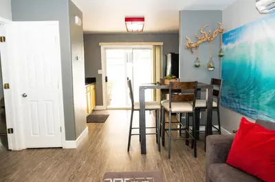 a living room with a table and chairs and a kitchen at The Hideaway in San Diego