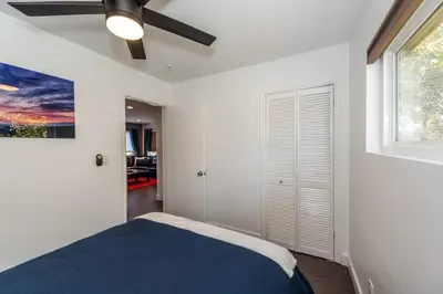 a bedroom with a bed and a ceiling fan at Canyon View in San Diego