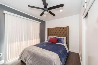 a bedroom with a bed with a ceiling fan at Canyon View in San Diego