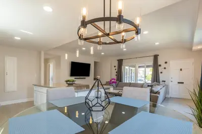 a dining room and living room with a glass table at Allure Retreat in San Diego