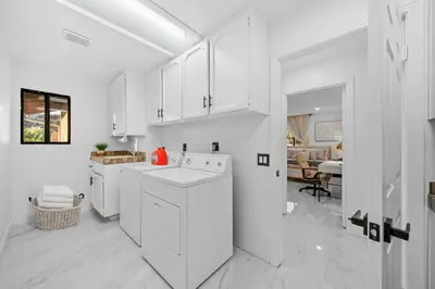 a white kitchen with white cabinets and a sink at Entire Private Home with 3 Bedrooms 2 Bathrooms, Mountain View, Jetted Tub, 2500 sqft, King Bed,Garage, Available Now in Jamul