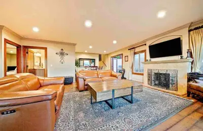 a living room with leather furniture and a fireplace at Stunning Views, Rooftop Vista, Pool & Spa in San Diego