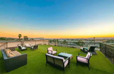 a patio with chairs and tables on a balcony at Stunning Views, Rooftop Vista, Pool & Spa in San Diego