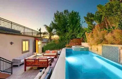 a swimming pool with a patio furniture and a house at Stunning Views, Rooftop Vista, Pool & Spa in San Diego