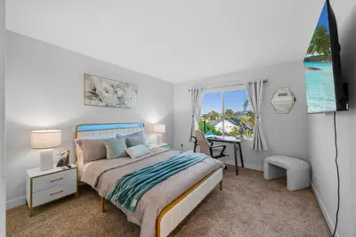 a bedroom with a bed and a desk and a window at Entire Private Home with 3 Bedrooms, Hot Tub, King Bed, Garage, Grand View, Available Now in San Diego