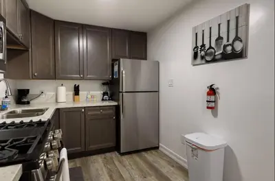 a kitchen with wooden cabinets and a stainless steel refrigerator at Central San Diego 2 BED Condo in San Diego