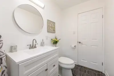 a white bathroom with a sink and a mirror at Central San Diego 2 BED Condo in San Diego