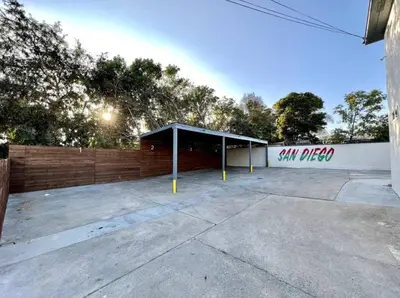a parking lot with asan pizza sign on a building at Central San Diego 2 BED Condo in San Diego