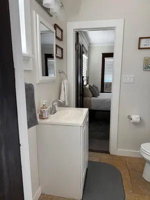 a white bathroom with a sink and a toilet at Cozy cottage in San Diego