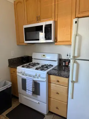 a kitchen with a white stove and a microwave at Cozy cottage in San Diego