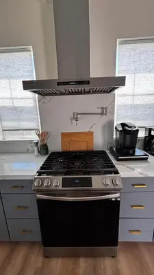 a stove top oven in a kitchen with two windows at San Diego Oasis Fire Pit, Putting Green, Near Everything in San Diego