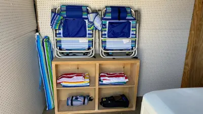 a small closet with folded towels and umbrellas at San Diego Oasis Fire Pit, Putting Green, Near Everything in San Diego