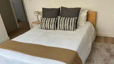 a large bed with pillows on it in a bedroom at San Diego Oasis Fire Pit, Putting Green, Near Everything in San Diego