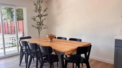 a dining room table with black chairs around it at San Diego Oasis Fire Pit, Putting Green, Near Everything in San Diego