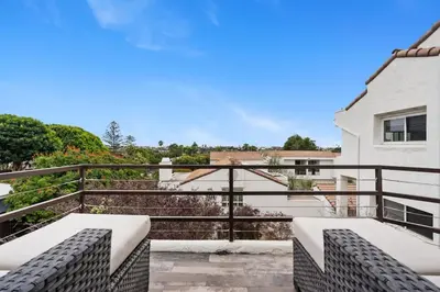 a balcony with a view of a building at New Cozy Leucadia Beach House with parking in Encinitas
