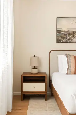 a bedroom with a bed and a nightstand with a lamp at Renovated Coastal 2BR - Stylish & Bright in San Diego
