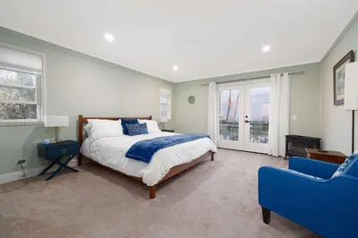 a bedroom with a bed and a blue couch at Luxury Home OceanView in San Diego