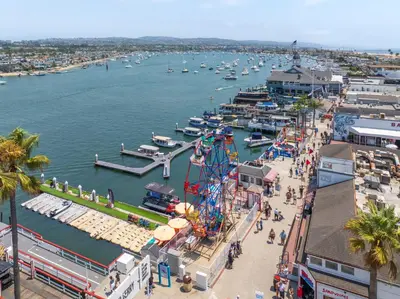 an aerial view of a marina with a ferris wheel at Sail & Sea in Newport Beach