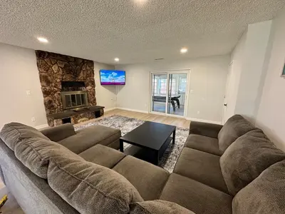 a living room with a large couch and a tv at Family Fun Getaway - 3BR - Games - BBQ Patio in Santee