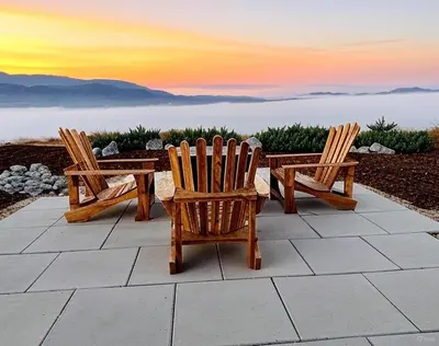 two chairs and a table with a sunset in the background at The Hilltop Haven - Romantic Getaway Suite in Temecula