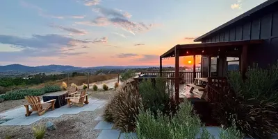 a house with a patio with a table and chairs at The Hilltop Haven - Romantic Getaway Suite in Temecula