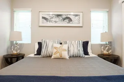 a bedroom with a bed with a starfish on it at Steps from Bay Ocean Villa in San Diego