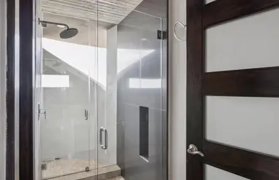 a glass shower door in a bathroom at The Wave House! Custom Gem with Panoramic Views, Fire Pit, BBQ, Pool Table in San Diego