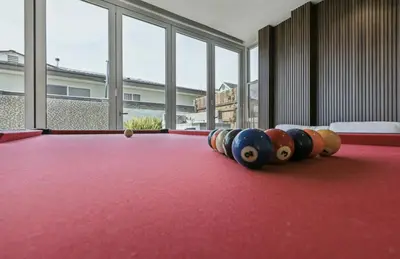 a group of bowling balls sitting on a red table at The Wave House! Custom Gem with Panoramic Views, Fire Pit, BBQ, Pool Table in San Diego