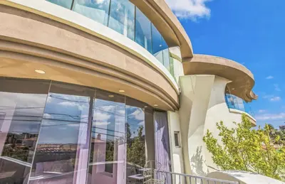 a building with a large window with a gargoyle at The Wave House! Custom Gem with Panoramic Views, Fire Pit, BBQ, Pool Table in San Diego