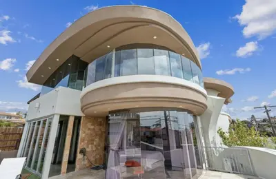a large glass building with a dome at The Wave House! Custom Gem with Panoramic Views, Fire Pit, BBQ, Pool Table in San Diego