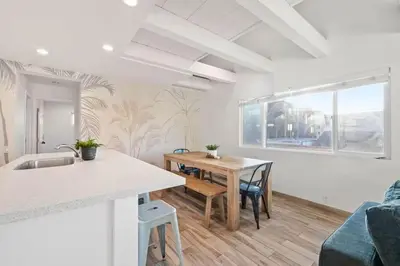 a kitchen and dining room with a table and chairs at Ocean Views Steps to Beach Rooftop Firepit in San Diego