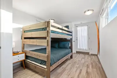 a bedroom with a bunk bed in a house at Ocean Views Steps to Beach Rooftop Firepit in San Diego